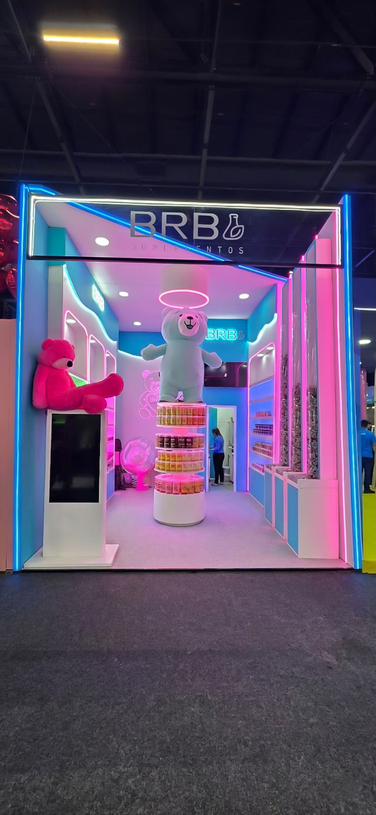 Stand da BRB Suplementos com neon rosa e azul montado pela Central Eventos
